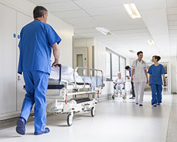 Nurse pushing a stretcher.